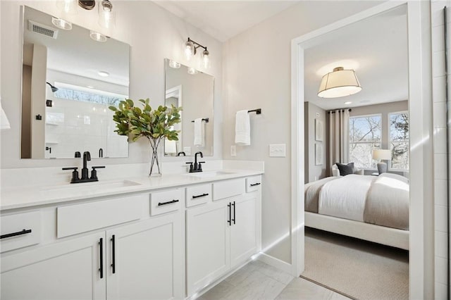 10391 Glacier Ln N, Maple Grove, MN 55369 - ensuite bathroom featuring tiled shower, double vanity, and baseboards