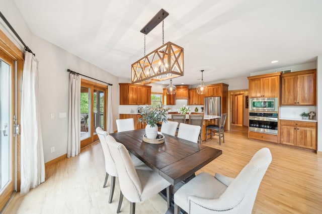dining area with light wood-style floors, recessed lighting, and baseboards