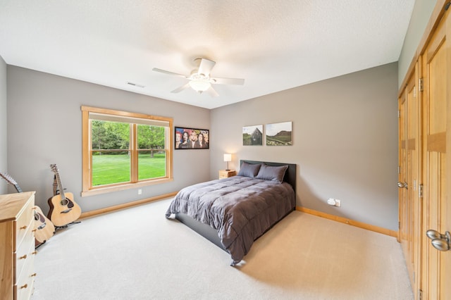 bedroom with carpet floors, baseboards, and a ceiling fan