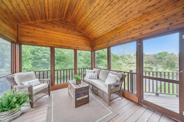sunroom / solarium with vaulted ceiling, an outdoor hangout area, and healthy amount of natural light