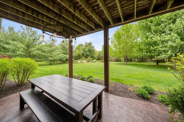 view of patio / terrace featuring view of scattered trees and outdoor dining area
