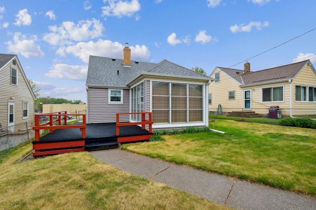 1224 Grotto St N, Saint Paul, MN 55117 - back of house with a shingled roof, a deck, a chimney, entry steps, and a sunroom