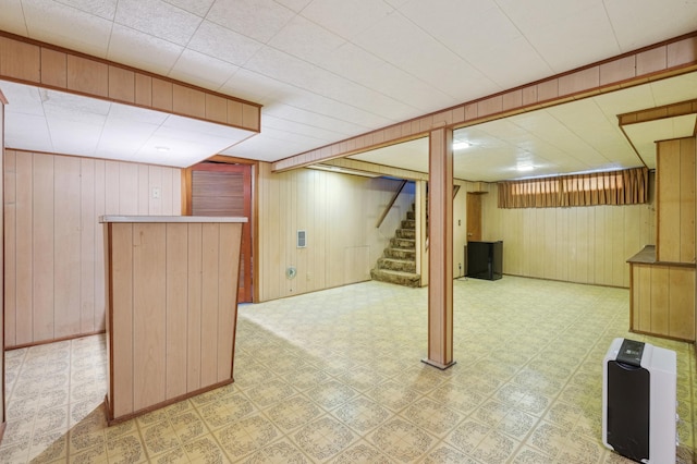 1224 Grotto St N, Saint Paul, MN 55117 - finished basement with stairs, a bar, wooden walls, and light flooring