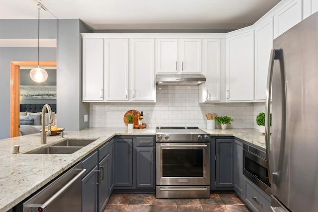 kitchen featuring appliances with stainless steel finishes, a sink, under cabinet range hood, and white cabinetry
