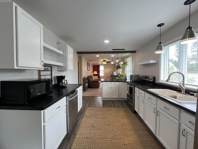 225 State St, Buhl, MN 55713 - kitchen featuring stainless steel appliances, open shelves, a sink, dark wood-type flooring, and dark countertops