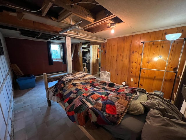 225 State St, Buhl, MN 55713 - bedroom with tile patterned floors and wood walls