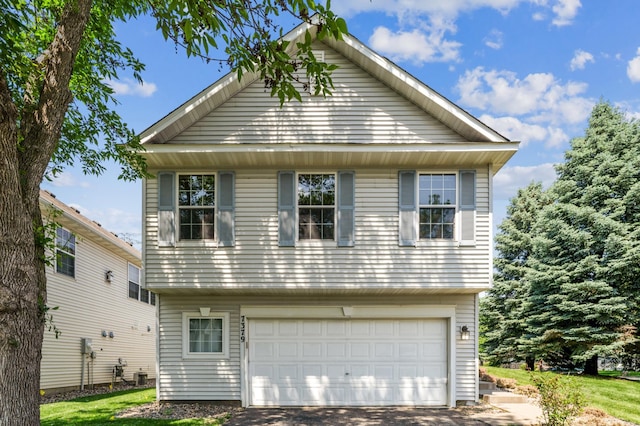 7379 Devin Ln, Shakopee, MN 55379 - view of front of home with a garage, asphalt driveway, and cooling unit