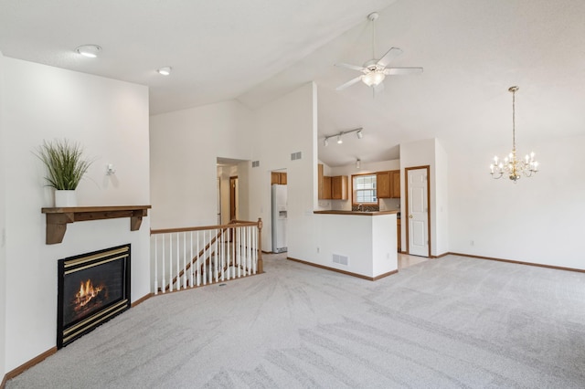 7379 Devin Ln, Shakopee, MN 55379 - unfurnished living room featuring baseboards, light colored carpet, a glass covered fireplace, a ceiling fan, and high vaulted ceiling