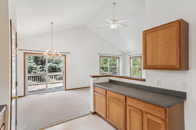 7379 Devin Ln, Shakopee, MN 55379 - kitchen with dark countertops, light colored carpet, ceiling fan, a chandelier, and high vaulted ceiling
