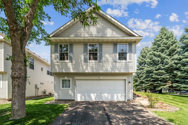 7379 Devin Ln, Shakopee, MN 55379 - view of front of house featuring asphalt driveway, a garage, and a front yard