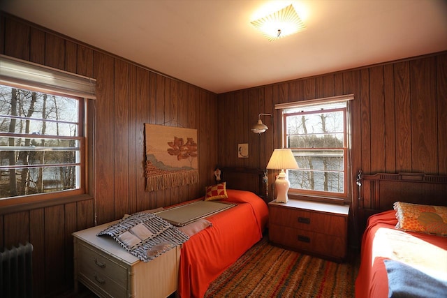 6565 White Pine Ln, Biwabik Twp, MN 55741 - bedroom with radiator heating unit, multiple windows, and wood walls