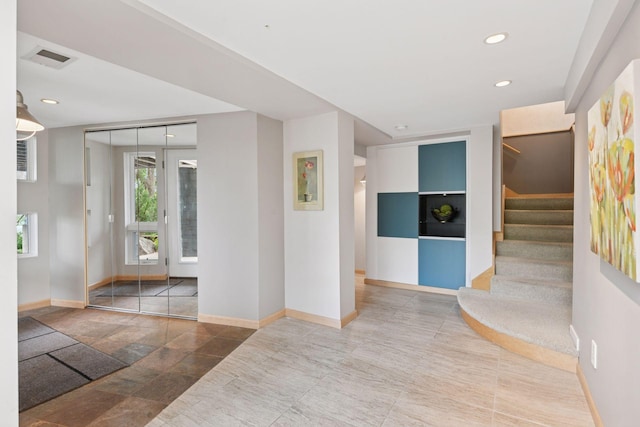 5016 Shady Oak Rd S, Minnetonka, MN 55343 - spare room featuring baseboards, stairway, recessed lighting, and stone finish floors