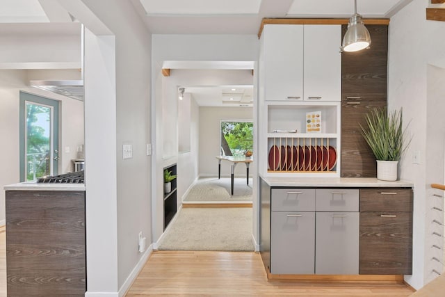 5016 Shady Oak Rd S, Minnetonka, MN 55343 - kitchen with light wood-style flooring, light countertops, open shelves, and baseboards