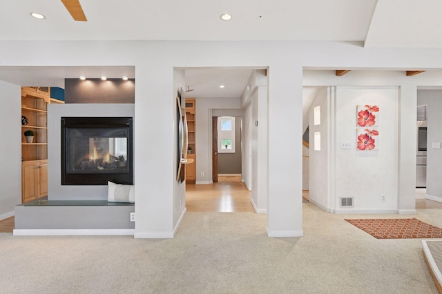 5016 Shady Oak Rd S, Minnetonka, MN 55343 - unfurnished living room featuring carpet, baseboards, recessed lighting, a multi sided fireplace, and built in features