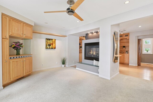 5016 Shady Oak Rd S, Minnetonka, MN 55343 - unfurnished living room featuring light carpet, ceiling fan, a glass covered fireplace, recessed lighting, and baseboards