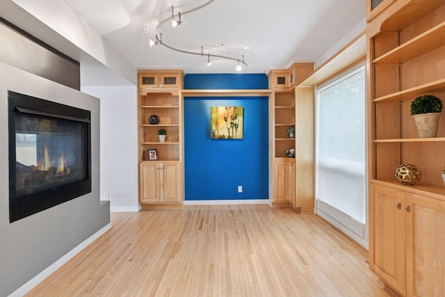 5016 Shady Oak Rd S, Minnetonka, MN 55343 - unfurnished living room with light wood-style flooring and baseboards