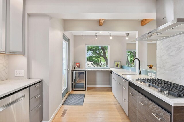 5016 Shady Oak Rd S, Minnetonka, MN 55343 - kitchen with beverage cooler, wall chimney exhaust hood, a sink, stainless steel gas cooktop, and light wood finished floors
