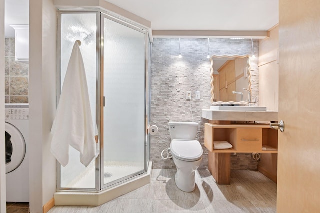 5016 Shady Oak Rd S, Minnetonka, MN 55343 - full bathroom with toilet, washer / dryer, a stall shower, vanity, and tile walls