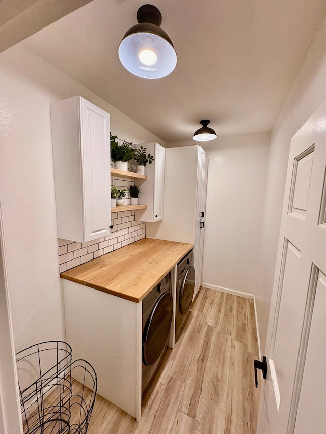 1622 82nd Ave NW, Williams, MN 56686 - washroom with light wood finished floors, cabinet space, and washer and dryer