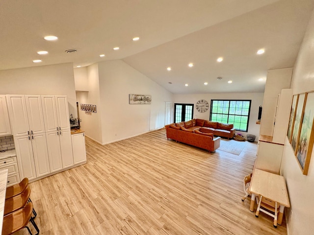 1622 82nd Ave NW, Williams, MN 56686 - living room featuring vaulted ceiling, light wood-type flooring, recessed lighting, and baseboards