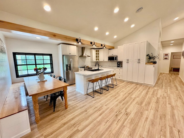 1622 82nd Ave NW, Williams, MN 56686 - kitchen featuring stainless steel appliances, wall chimney exhaust hood, a sink, white cabinets, and recessed lighting