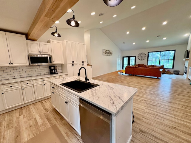 1622 82nd Ave NW, Williams, MN 56686 - kitchen with appliances with stainless steel finishes, a sink, open floor plan, light wood-type flooring, and white cabinetry