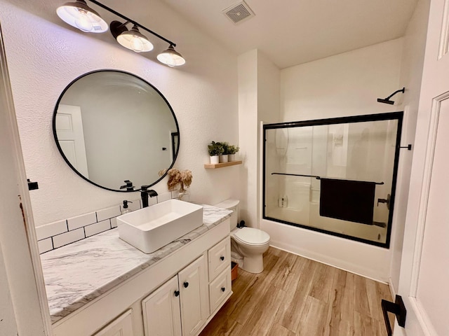 1622 82nd Ave NW, Williams, MN 56686 - full bath with toilet, vanity, wood finished floors, and enclosed tub / shower combo