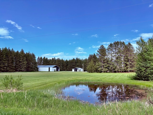 1622 82nd Ave NW, Williams, MN 56686 - view of grassy yard with a water view, an outdoor structure, and a wooded view