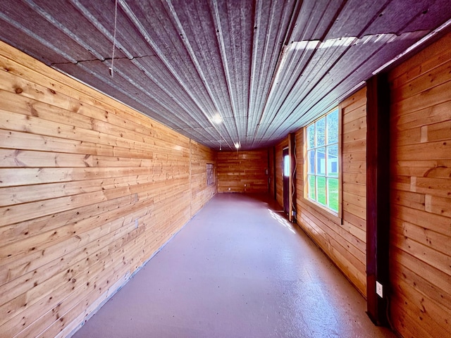 1622 82nd Ave NW, Williams, MN 56686 - corridor featuring wood walls, wooden ceiling, and finished concrete floors