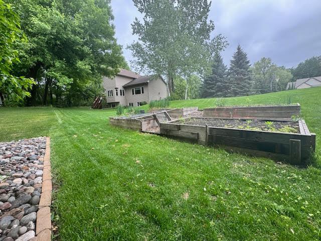 15224 Swallow St NW, Andover, MN 55304 - view of green lawn featuring a garden