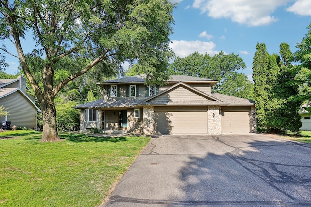 16905 Jalisco Ter W, Lakeville, MN 55044 - view of front facade featuring driveway, an attached garage, a front yard, a porch, and stone siding