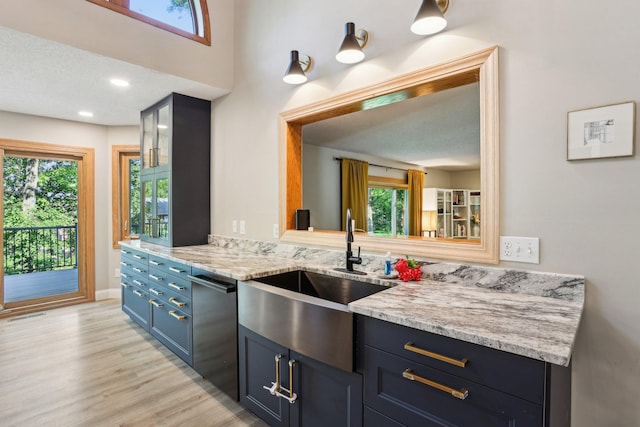 16905 Jalisco Ter W, Lakeville, MN 55044 - kitchen with stainless steel dishwasher, blue cabinets, light wood finished floors, and light stone countertops