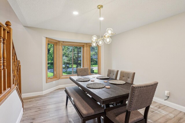 16905 Jalisco Ter W, Lakeville, MN 55044 - dining room featuring light wood-style floors, recessed lighting, a chandelier, and stairway