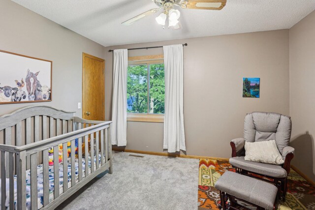 16905 Jalisco Ter W, Lakeville, MN 55044 - carpeted bedroom featuring a nursery area, a ceiling fan, and a textured ceiling