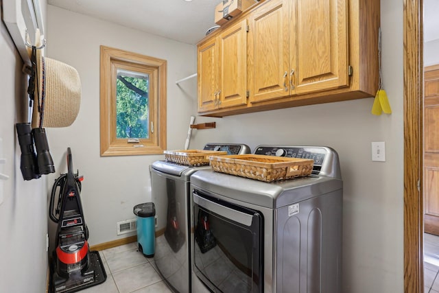 16905 Jalisco Ter W, Lakeville, MN 55044 - laundry room with cabinet space, washing machine and dryer, and light tile patterned floors