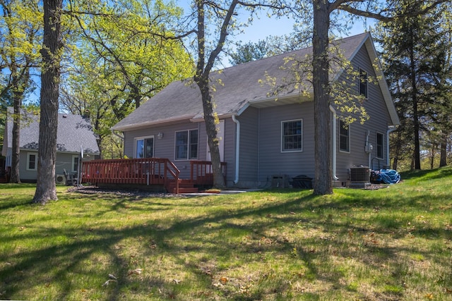 601 Idlewild St Unit 102, Balsam Lake, WI 54810 - rear view of property featuring a wooden deck, a yard, a shingled roof, and central air condition unit