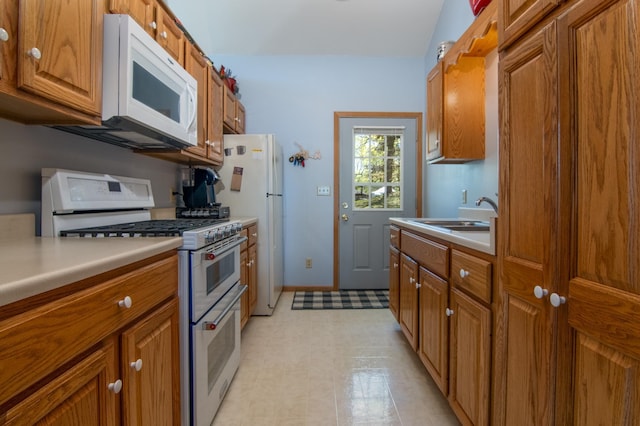 601 Idlewild St Unit 102, Balsam Lake, WI 54810 - kitchen with white appliances, a sink, and brown cabinets