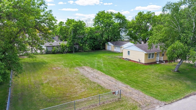 1402 7th St N, Saint Cloud, MN 56303 - view of yard featuring driveway, a garage, and view of wooded area