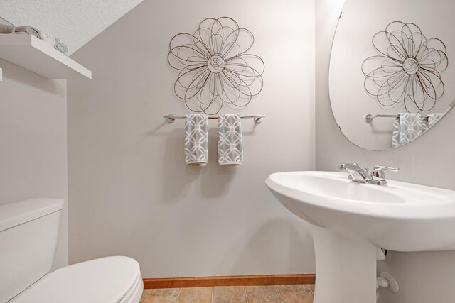 3314 Hazel Trl Unit G, Woodbury, MN 55129 - half bathroom with toilet, baseboards, a textured ceiling, and a sink