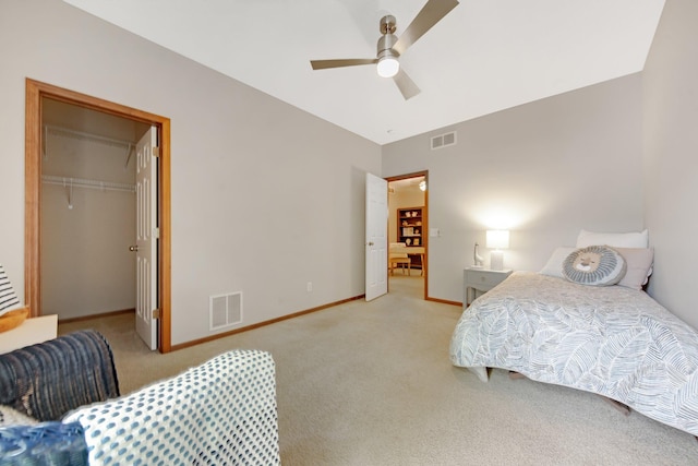 3314 Hazel Trl Unit G, Woodbury, MN 55129 - bedroom with light colored carpet, baseboards, a walk in closet, and a ceiling fan