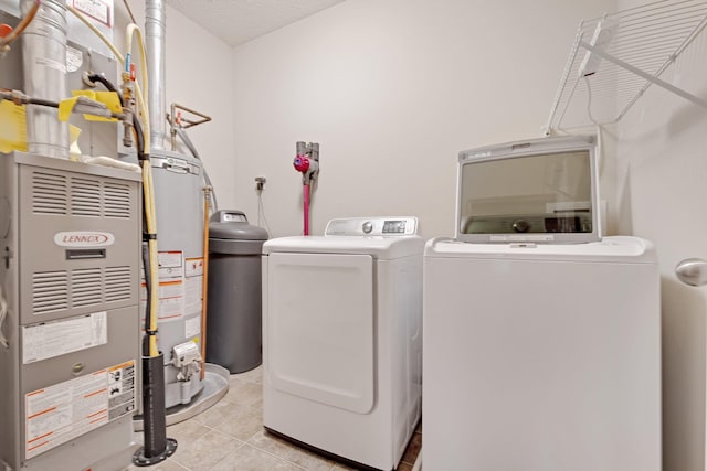 3314 Hazel Trl Unit G, Woodbury, MN 55129 - washroom featuring washer and clothes dryer, water heater, light tile patterned flooring, and heating unit