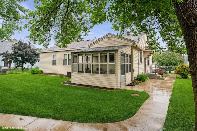718 Atwood St S, Shakopee, MN 55379 - rear view of property featuring a sunroom and roof with shingles