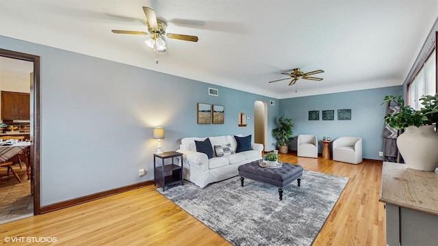 718 Atwood St S, Shakopee, MN 55379 - living area with a ceiling fan, arched walkways, light wood-type flooring, and baseboards