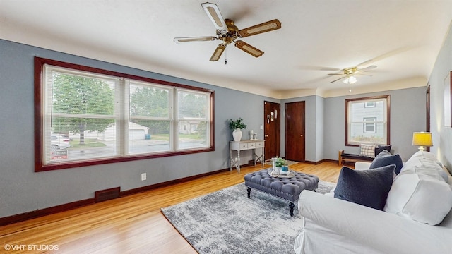 718 Atwood St S, Shakopee, MN 55379 - living area featuring a ceiling fan, light wood finished floors, and baseboards