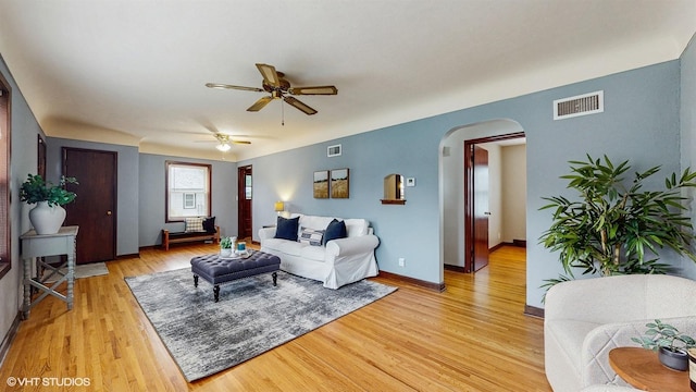 718 Atwood St S, Shakopee, MN 55379 - living area with arched walkways, ceiling fan, light wood-type flooring, and baseboards