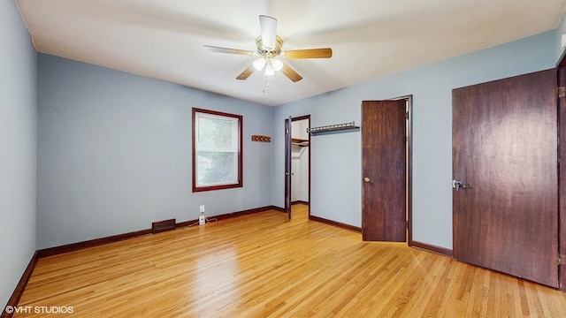 718 Atwood St S, Shakopee, MN 55379 - unfurnished bedroom featuring light wood finished floors, baseboards, two closets, and a ceiling fan