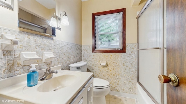 718 Atwood St S, Shakopee, MN 55379 - bathroom featuring toilet, vanity, tile patterned floors, wainscoting, and a shower