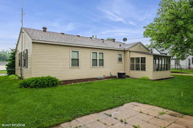 718 Atwood St S, Shakopee, MN 55379 - back of house featuring central air condition unit, a sunroom, a shingled roof, and a patio