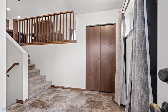 foyer entrance with baseboards and stone finish floors