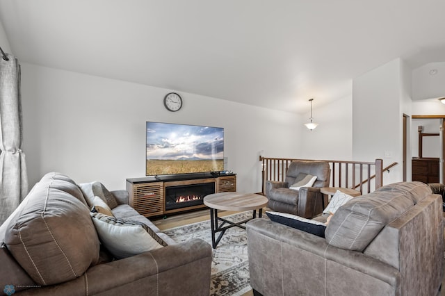 living area featuring wood finished floors and lofted ceiling